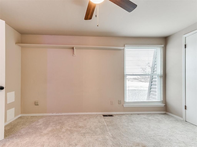 unfurnished room featuring ceiling fan and light colored carpet