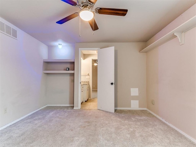 unfurnished bedroom featuring light carpet and ceiling fan