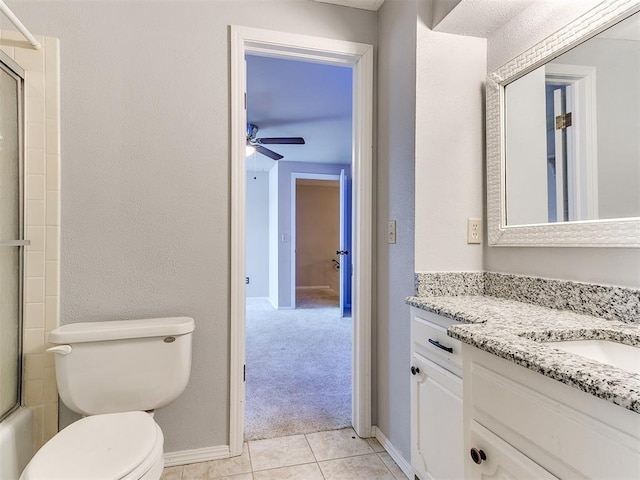 full bathroom featuring tile patterned floors, toilet, combined bath / shower with glass door, vanity, and ceiling fan