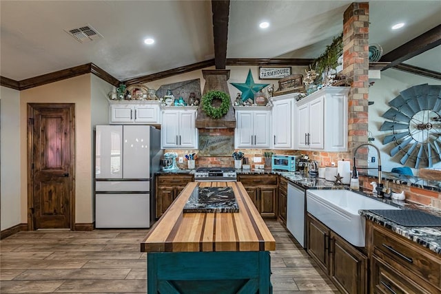 kitchen featuring sink, wooden counters, white cabinets, and appliances with stainless steel finishes