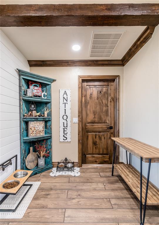 interior space featuring hardwood / wood-style flooring and crown molding