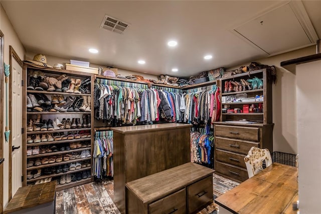 spacious closet featuring dark hardwood / wood-style floors