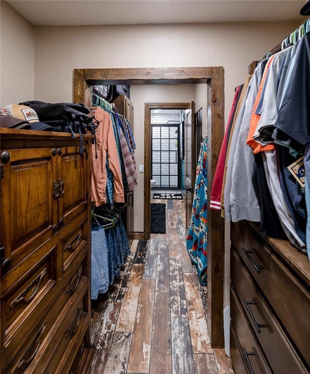 spacious closet with dark wood-type flooring