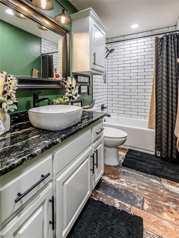 full bathroom featuring vanity, toilet, and shower / bath combo with shower curtain