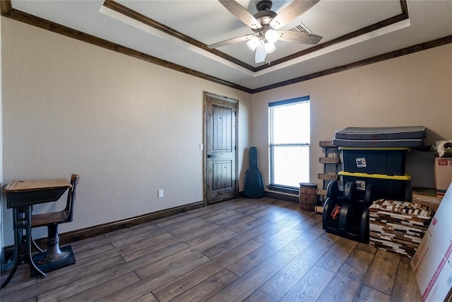 office featuring a raised ceiling, ornamental molding, and dark hardwood / wood-style floors