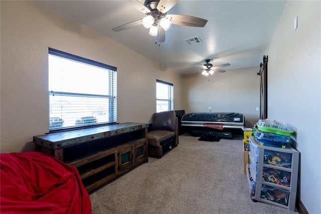 interior space with carpet flooring and ceiling fan