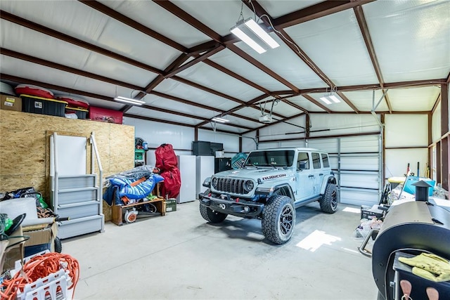 garage featuring a garage door opener and white refrigerator