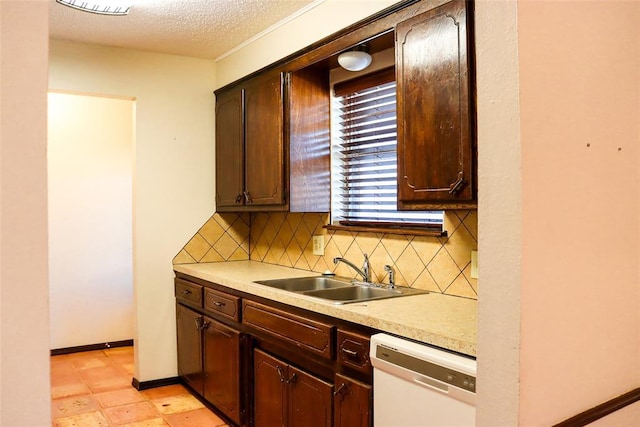 kitchen featuring dishwasher, sink, dark brown cabinetry, and decorative backsplash