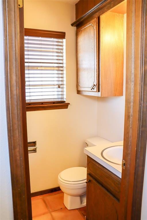 bathroom with tile patterned flooring, vanity, and toilet