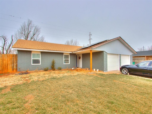 ranch-style home featuring a garage and a front yard