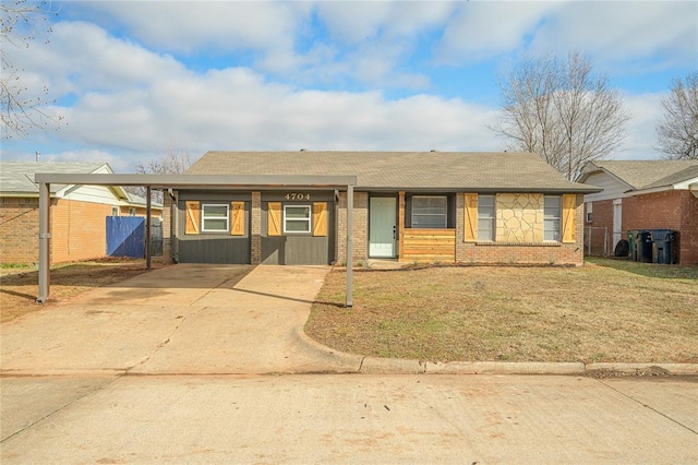 single story home featuring brick siding, concrete driveway, and fence