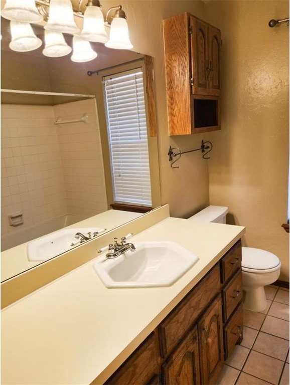 full bathroom featuring a shower, vanity, tile patterned flooring, and toilet