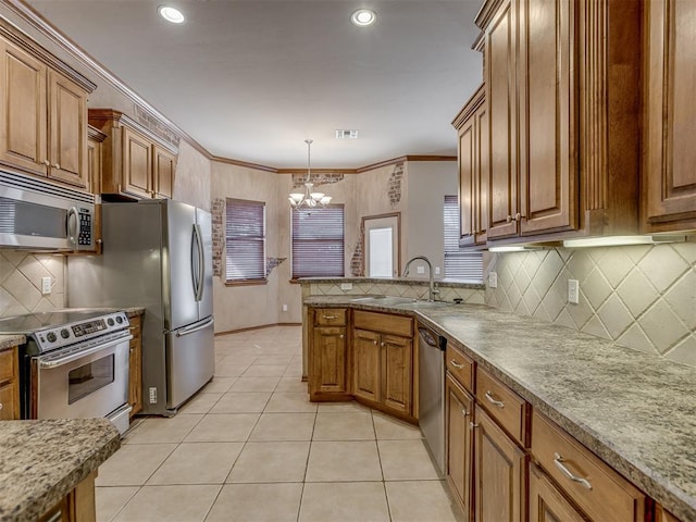 kitchen with appliances with stainless steel finishes, brown cabinets, and a sink