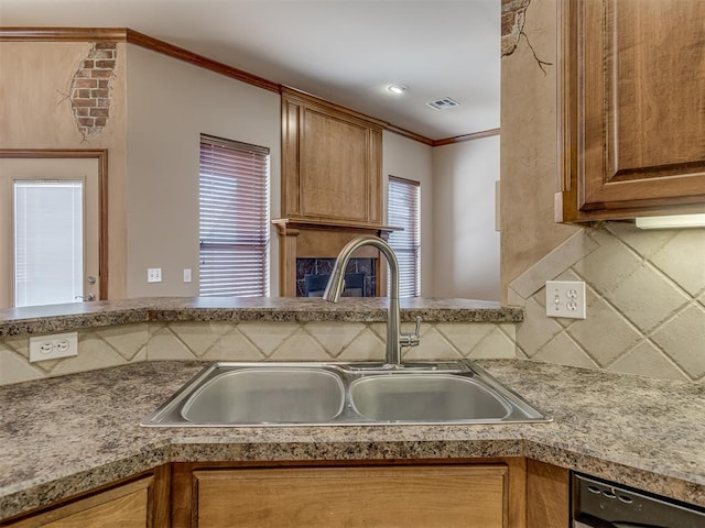 kitchen with visible vents, ornamental molding, backsplash, a sink, and stainless steel dishwasher