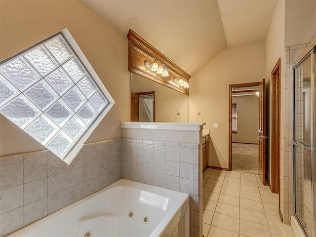 full bathroom featuring a stall shower, a tub with jets, vaulted ceiling, and tile patterned floors