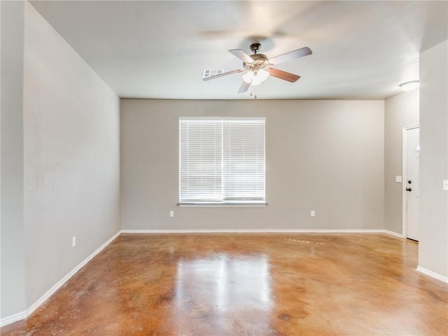 empty room featuring ceiling fan and concrete floors