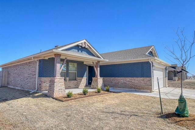 view of front facade with a garage, brick siding, and driveway