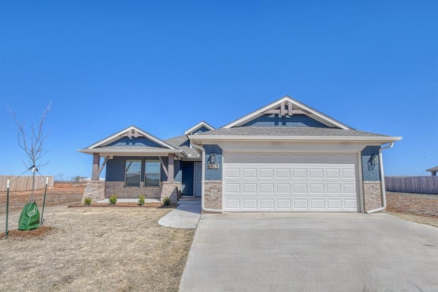 view of front facade with concrete driveway, a garage, fence, and brick siding