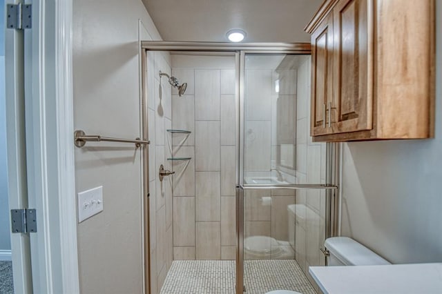 full bath featuring vanity, a shower stall, and toilet