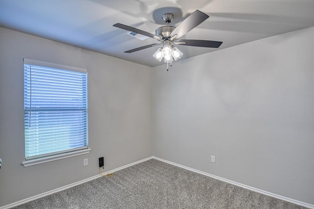 spare room featuring carpet flooring, a ceiling fan, and baseboards