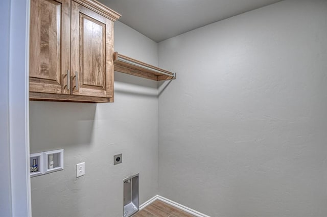 laundry room with baseboards, hookup for a washing machine, wood finished floors, cabinet space, and hookup for an electric dryer