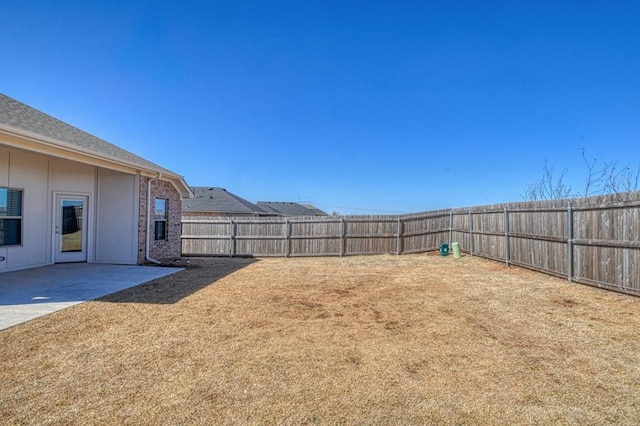 view of yard with a patio and a fenced backyard