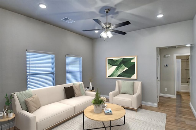 living area with visible vents, wood finished floors, recessed lighting, baseboards, and ceiling fan