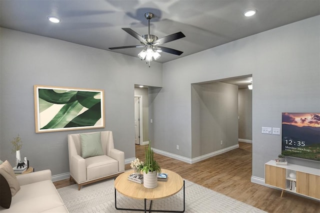 living room featuring recessed lighting, baseboards, wood finished floors, and a ceiling fan