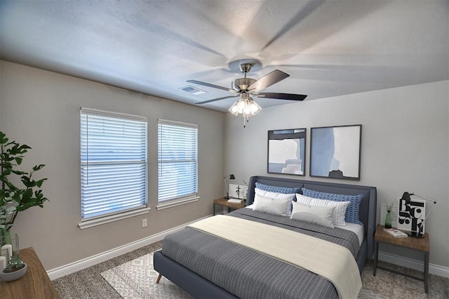 carpeted bedroom featuring visible vents, ceiling fan, and baseboards