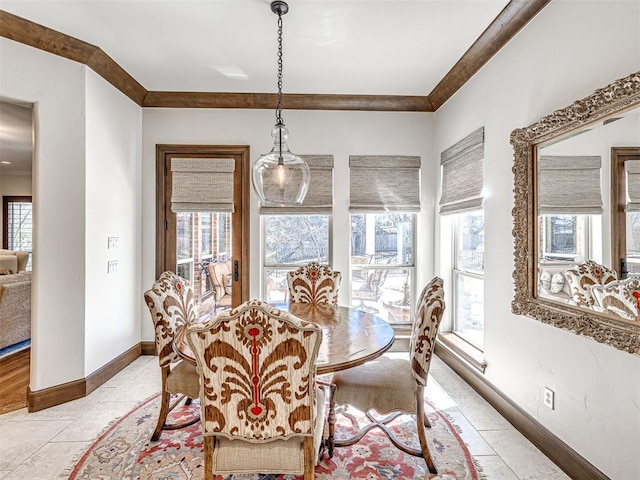 dining room featuring light tile patterned floors, ornamental molding, and baseboards