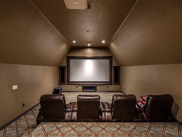 home theater with a textured ceiling, a textured wall, vaulted ceiling, and carpet flooring