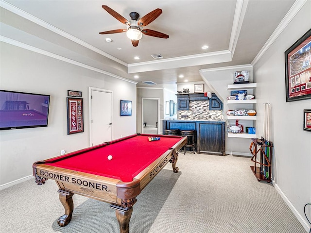 recreation room with carpet floors, visible vents, a raised ceiling, and crown molding