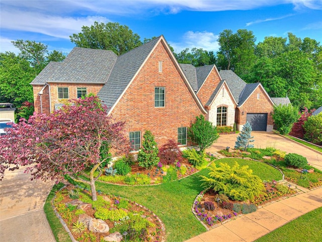 405 Flint Ridge Ct, Norman, OK 73072 - view of front of home with brick siding, concrete driveway, and a front yard