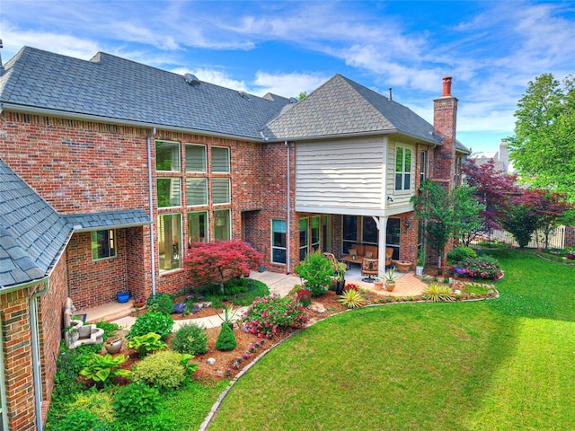 405 Flint Ridge Ct, Norman, OK 73072 - back of property featuring brick siding, a patio area, a yard, and a chimney