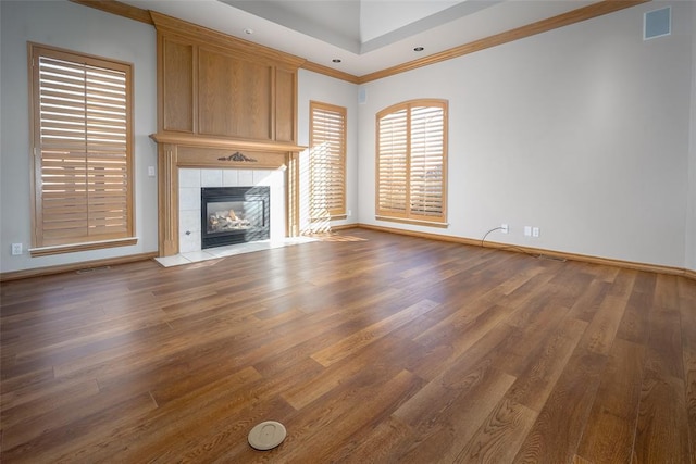 1601 Vandivort Pl, Edmond, OK 73034 - unfurnished living room featuring wood finished floors, baseboards, ornamental molding, and a fireplace