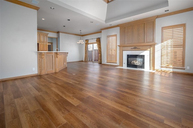 1601 Vandivort Pl, Edmond, OK 73034 - unfurnished living room with a chandelier, ornamental molding, a fireplace, wood finished floors, and recessed lighting