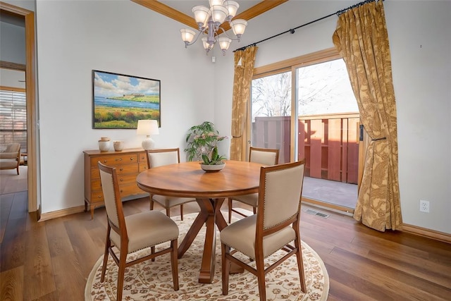 1601 Vandivort Pl, Edmond, OK 73034 - dining space featuring wood finished floors, a chandelier, and baseboards