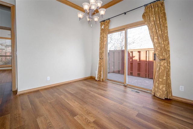 1601 Vandivort Pl, Edmond, OK 73034 - unfurnished room featuring a chandelier, wood finished floors, and baseboards