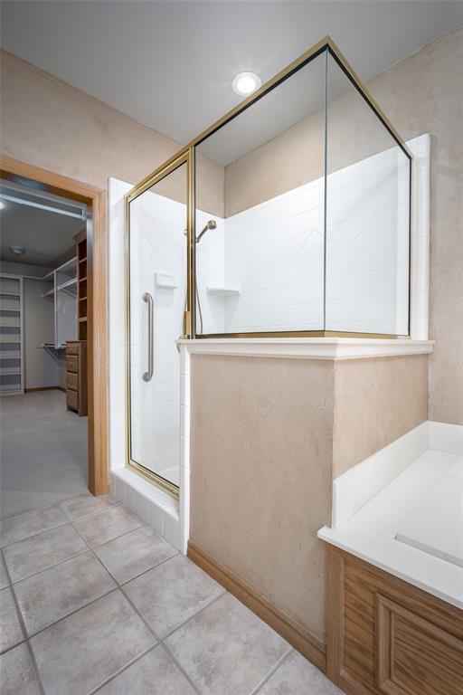 1601 Vandivort Pl, Edmond, OK 73034 - full bathroom with a shower stall and a walk in closet