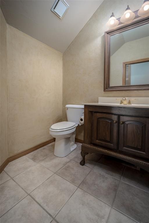 1601 Vandivort Pl, Edmond, OK 73034 - half bathroom featuring lofted ceiling, toilet, vanity, and tile patterned floors