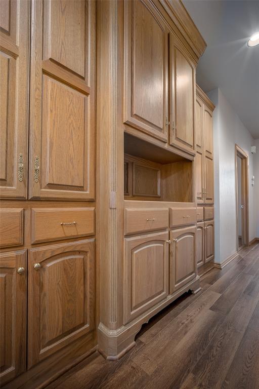 1601 Vandivort Pl, Edmond, OK 73034 - detailed view of wood finished floors and baseboards