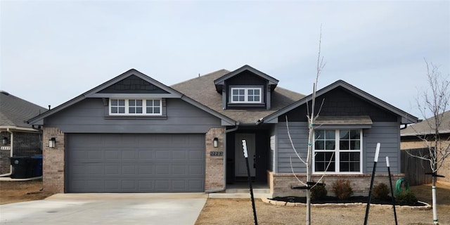 view of front of house featuring a garage, driveway, and brick siding