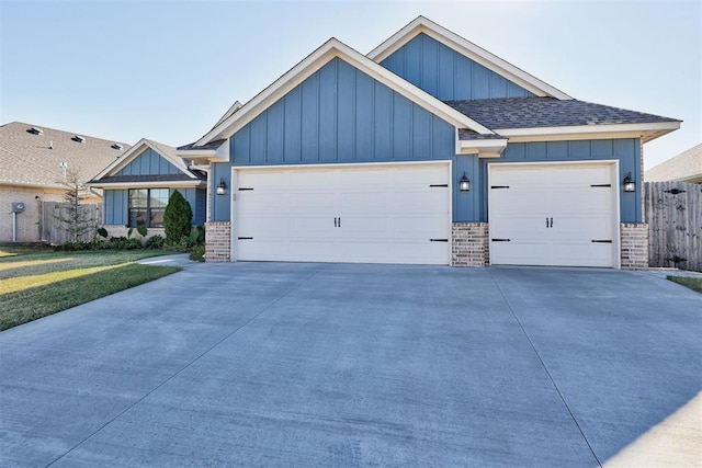 view of front facade with board and batten siding, brick siding, driveway, and an attached garage