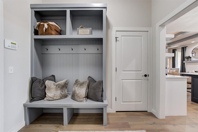 mudroom featuring baseboards and light wood finished floors