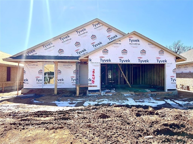 unfinished property featuring an attached garage