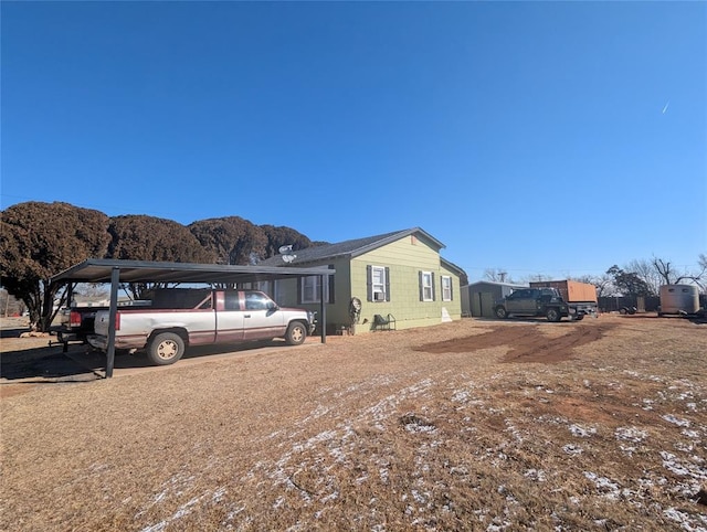 view of front of property featuring a carport