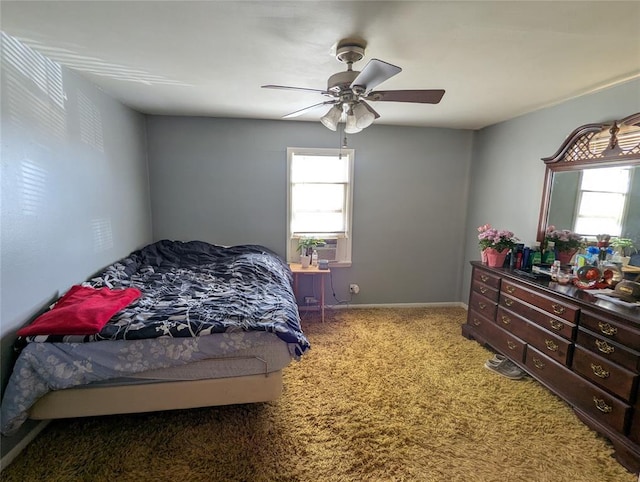 carpeted bedroom featuring ceiling fan, multiple windows, and cooling unit