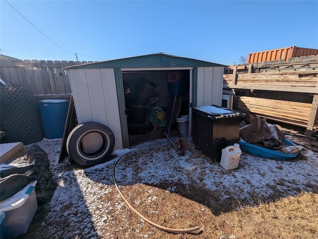 view of shed featuring fence