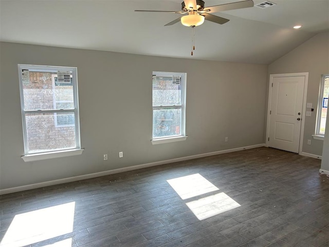 spare room featuring dark wood-type flooring, vaulted ceiling, and ceiling fan