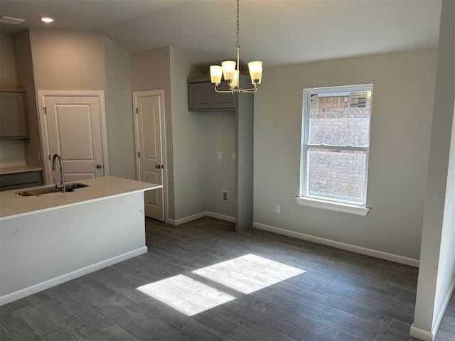 unfurnished dining area with dark hardwood / wood-style flooring, sink, a chandelier, and vaulted ceiling